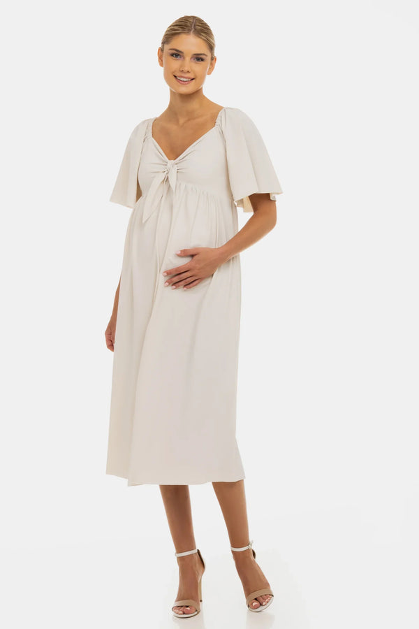 Φόρεμα εγκυμοσύνης με σούρες και φιόγκο – σε ανοιχτό μπεζ - - soonMAMA - Η σωστή προσθήκη στην κομψή και άνετη εγκυμοσύνη! - Παλτά για έγκυες
